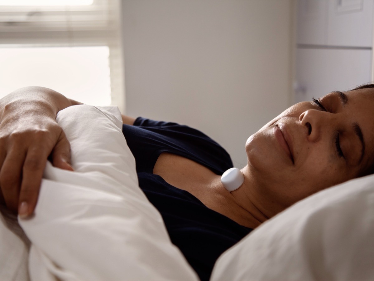 Woman sleeping with AcuPebble on